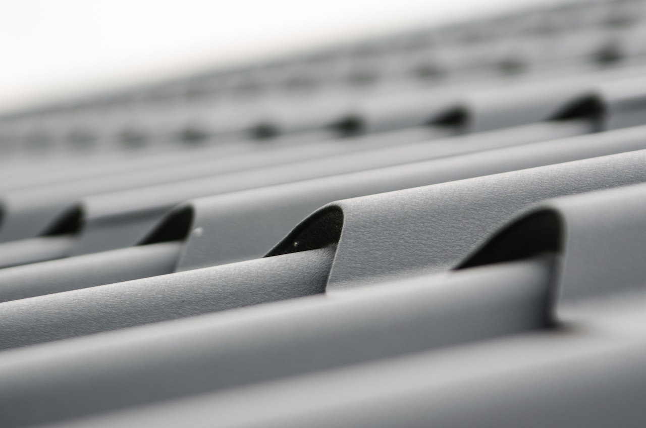 Close-up of a freshly installed standing seam metal roof in gray steel